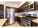 Kitchen featuring stainless steel appliances and dark cabinets at 7936 Dexter Falls St, Las Vegas, NV 89149