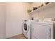 Bright laundry area equipped with modern washer and dryer and shelf space for storage at 7936 Dexter Falls St, Las Vegas, NV 89149