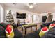 Open living room featuring dark furnishings, wood flooring, lots of natural light, and a staircase at 7936 Dexter Falls St, Las Vegas, NV 89149