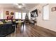 Living room featuring a ceiling fan, wood flooring, comfortable seating, and a Christmas tree at 7936 Dexter Falls St, Las Vegas, NV 89149