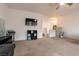 Spacious living room featuring a ceiling fan, neutral walls, and plush carpeting at 7936 Dexter Falls St, Las Vegas, NV 89149