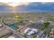 Aerial view of community clubhouse, pool, tennis courts, and parking lot at 2132 Idaho Falls Dr, Henderson, NV 89044