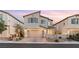 Two-story house with a neutral exterior and landscaped yard at 23 Papavero Ct, Henderson, NV 89011