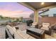 Covered patio with wicker furniture, fire pit, and grill at 23 Papavero Ct, Henderson, NV 89011