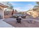 Inviting outdoor space with a fire pit, lounge seating, and a charming stone patio at 260 E Desert Rose Dr, Henderson, NV 89015