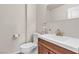 Half bathroom with tile flooring, modern fixtures, a toilet, and a sink with a wood cabinet at 260 E Desert Rose Dr, Henderson, NV 89015