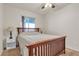 Cozy bedroom with wood-frame bed and a bright sunny window at 260 E Desert Rose Dr, Henderson, NV 89015