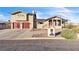 Two-story home featuring desert landscaping, a mailbox, and a paved driveway at 260 E Desert Rose Dr, Henderson, NV 89015