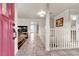 Home foyer featuring tile flooring, white railing, a staircase, and a pink front door at 260 E Desert Rose Dr, Henderson, NV 89015