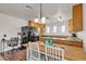 Functional kitchen with wood floors and cabinets, desk area, and breakfast bar at 260 E Desert Rose Dr, Henderson, NV 89015