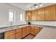 Bright kitchen with wood cabinets, neutral counters and dual basin sink at 260 E Desert Rose Dr, Henderson, NV 89015