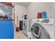 Practical laundry area with modern machines and storage solutions for household supplies at 260 E Desert Rose Dr, Henderson, NV 89015