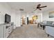 Open concept living room with neutral carpet, fan, and view to the kitchen at 260 E Desert Rose Dr, Henderson, NV 89015