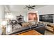 Inviting living room features a brick fireplace, ceiling fan, and an open floor plan at 260 E Desert Rose Dr, Henderson, NV 89015