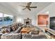 Living room featuring a fireplace, leather sectional sofa, tile flooring, and a large window view at 260 E Desert Rose Dr, Henderson, NV 89015