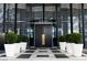 Modern building entrance with black metal doors, potted plants, and a geometric tiled floor at 4471 Dean Martin Dr # 801, Las Vegas, NV 89103