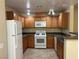 Modern kitchen with wood cabinets and appliances at 4725 Basilicata Ln # 102, North Las Vegas, NV 89084