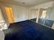 Spacious bedroom with mirrored closet doors and blue carpet at 5161 Lindell Rd # 107, Las Vegas, NV 89118