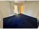 Bright bedroom with blue carpet and access to hallway at 5161 Lindell Rd # 107, Las Vegas, NV 89118