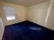 Spacious bedroom with blue carpet and a window at 5161 Lindell Rd # 107, Las Vegas, NV 89118