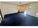 Living room with blue carpet and access to patio at 5161 Lindell Rd # 107, Las Vegas, NV 89118