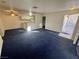 Living room with blue carpet, kitchen, and access to patio at 5161 Lindell Rd # 107, Las Vegas, NV 89118