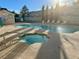 Community pool and spa with lounge chairs at 5161 Lindell Rd # 107, Las Vegas, NV 89118