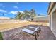 Spacious backyard with brick pavers and lounge chairs at 6316 W Gowan Rd, Las Vegas, NV 89108