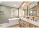 Bathroom with soaking tub, double vanity, and modern fixtures at 6316 W Gowan Rd, Las Vegas, NV 89108