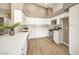 Modern kitchen with white cabinets, quartz countertops, and stainless steel appliances at 6316 W Gowan Rd, Las Vegas, NV 89108