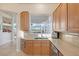 Kitchen with wood cabinets, granite counters, and appliances at 9112 Eagle Ridge Dr, Las Vegas, NV 89134