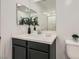 Modern bathroom with dark vanity, white countertop, and a large mirror at 965 Nevada State Dr # 1101, Henderson, NV 89002