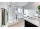 Modern bathroom featuring a glass-enclosed shower and tub, complemented by sleek fixtures and a neutral color palette at 965 Nevada State Dr # 1101, Henderson, NV 89002