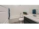 Clean bathroom with white tub and vanity, dark cabinets, and tile floor at 965 Nevada State Dr # 1101, Henderson, NV 89002