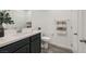 Modern bathroom with dark vanity, quartz countertop, and tile floor at 965 Nevada State Dr # 1101, Henderson, NV 89002