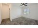 Bright bedroom with grey carpet, ceiling fan, and window with blinds at 965 Nevada State Dr # 1101, Henderson, NV 89002