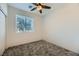 Bright bedroom featuring gray carpeting and a ceiling fan at 965 Nevada State Dr # 1101, Henderson, NV 89002