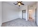 Bright bedroom with carpet, a ceiling fan, closet, and door to the bathroom at 965 Nevada State Dr # 1101, Henderson, NV 89002