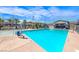 Sparkling community pool with lounge chairs, umbrellas and palm trees providing a resort-like atmosphere at 965 Nevada State Dr # 1101, Henderson, NV 89002