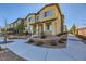 Tan two-story townhome with gray shutters, landscaping, and walkway at 965 Nevada State Dr # 1101, Henderson, NV 89002