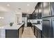 Modern kitchen with dark cabinetry, quartz countertops, and island at 965 Nevada State Dr # 1101, Henderson, NV 89002