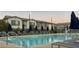 Community pool with lounge chairs and umbrellas at 965 Nevada State Dr # 1101, Henderson, NV 89002