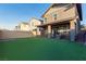 Spacious backyard with artificial turf and partial view of the house at 361 Andy Wheeler Dr, Henderson, NV 89011