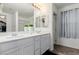 Ensuite bathroom with a double sink vanity and a framed mirror at 361 Andy Wheeler Dr, Henderson, NV 89011