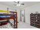 Cozy bedroom featuring a bunk bed, ceiling fan, and neutral tones at 361 Andy Wheeler Dr, Henderson, NV 89011