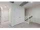 Hallway with white interior doors, white bannister, and neutral carpet at 361 Andy Wheeler Dr, Henderson, NV 89011