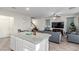 Open-concept living room with view of the kitchen and staircase at 361 Andy Wheeler Dr, Henderson, NV 89011