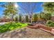 Landscaped backyard with artificial turf and brick accents at 4129 Cackling Goose Dr, North Las Vegas, NV 89084