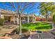 Artificial turf backyard with mature trees and seating area at 4129 Cackling Goose Dr, North Las Vegas, NV 89084