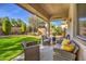 Relaxing backyard patio with seating area and artificial turf at 4129 Cackling Goose Dr, North Las Vegas, NV 89084